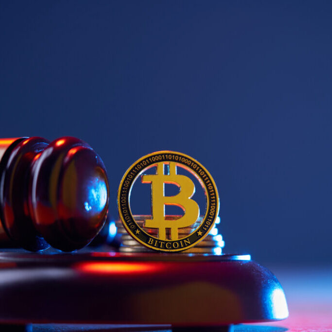 Bitcoin, the judge's gavel on blue background table. E-business, Finance. virtual currency.